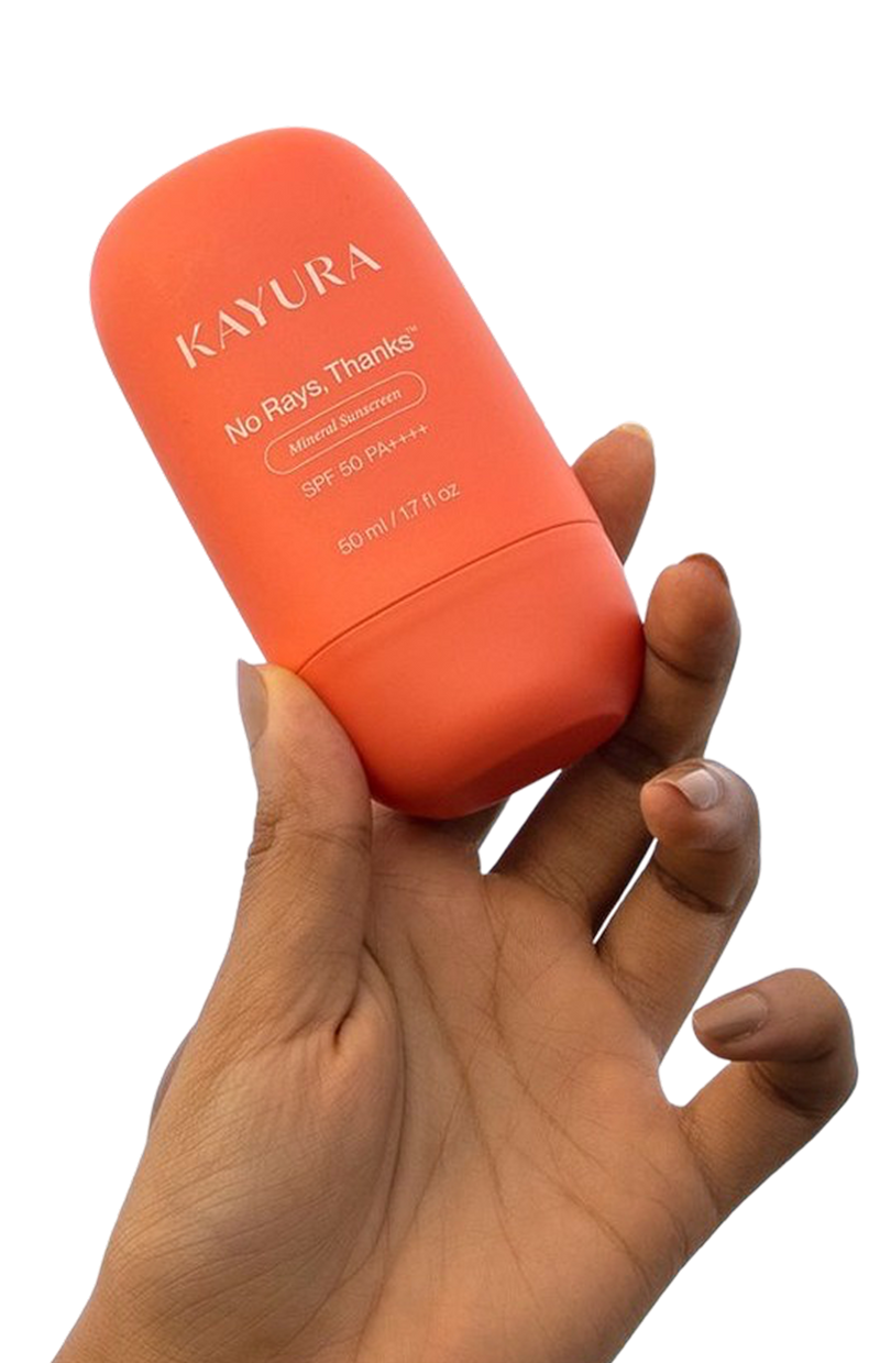 Hand holding No Rays, Thanks mineral sunscreen against a blue sky